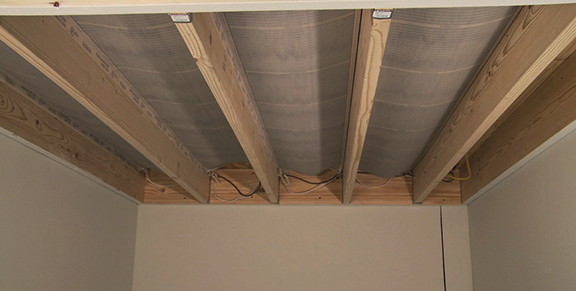 RetroHeat floor heating elements stapled up between floor joists.